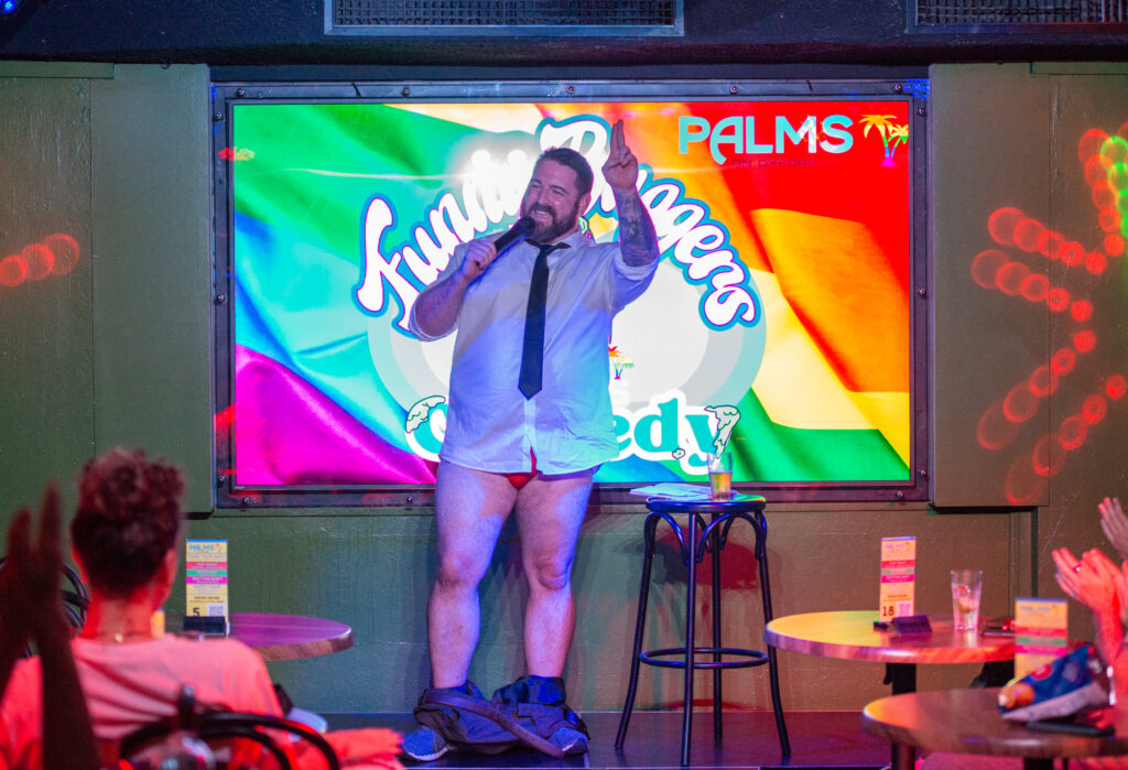 Chris Knight performing stand-up comedy on stage